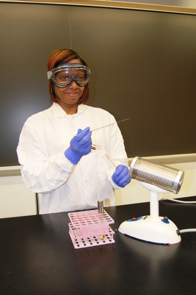 Photograph showing how to remove the cap of a culture tube using the little finger of your loop hand.